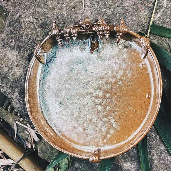 VividAion handcrafted WaMao ceramic cat plate in bronze glaze, earthy tones blending ancient and modern aesthetics.