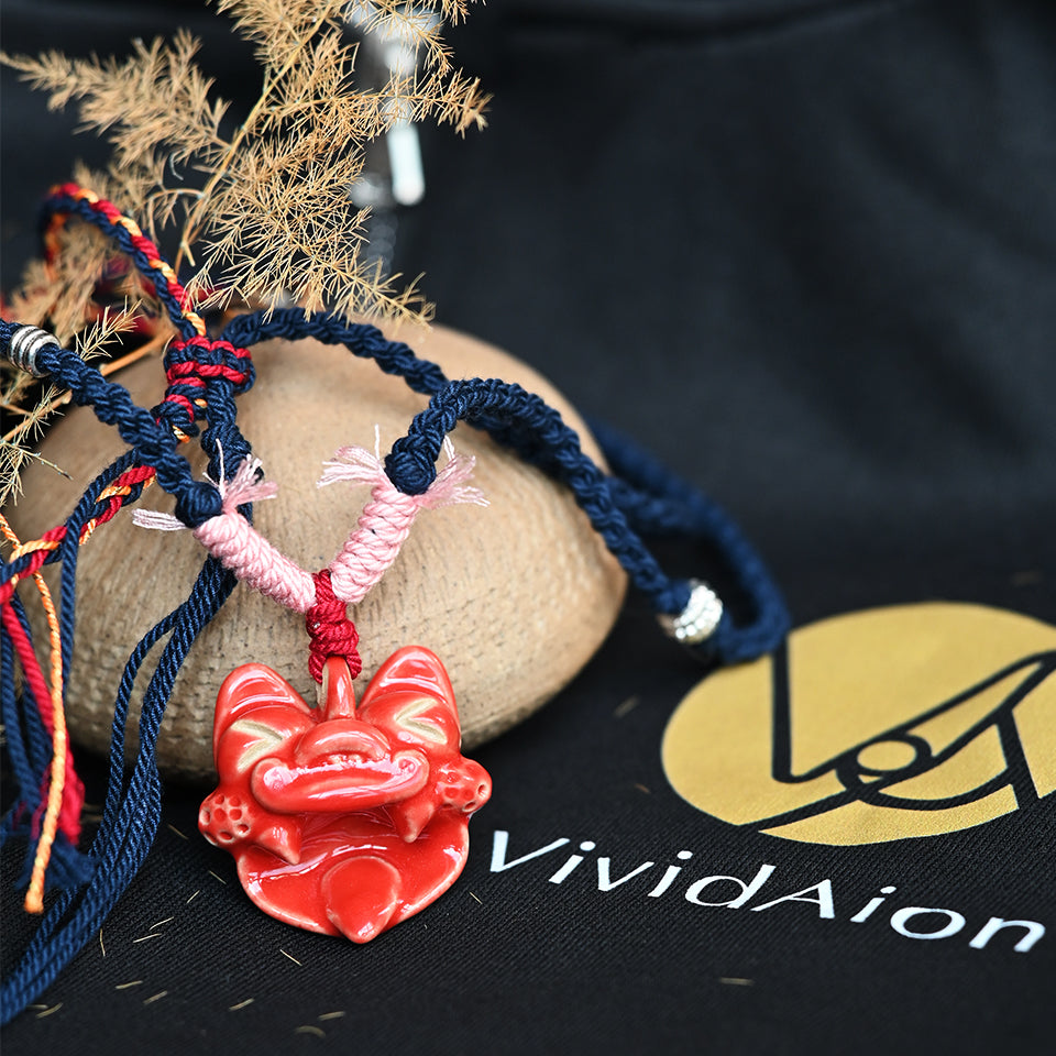 Crimson Flame ceramic WaMao necklace by VividAion, hand-painted in red glaze symbolizing strength, vitality, and ancient guardian power.