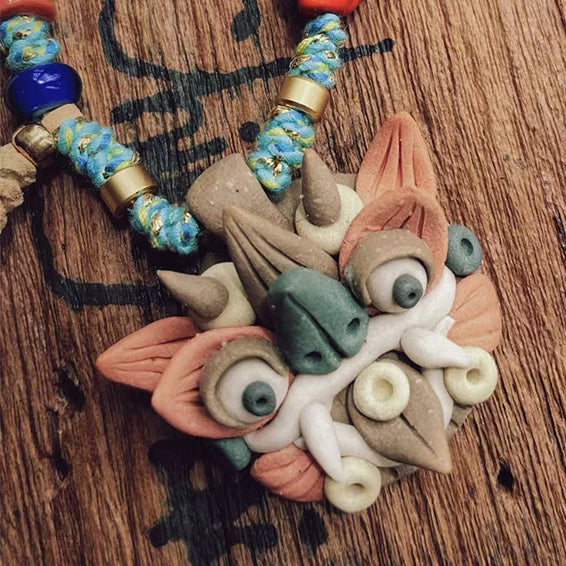 Multicolor handcrafted WaMao pendant necklace (Style B) by VividAion Liang Yu, expressing joyful artistry and cultural guardian charm.