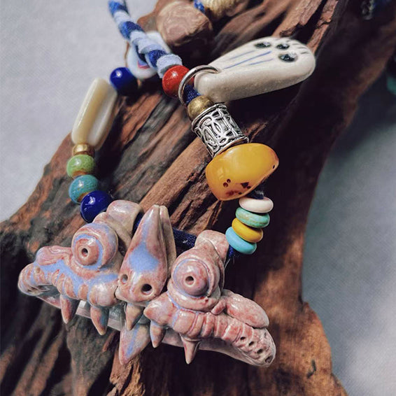 Pink WaMao pendant necklace handcrafted by VividAion Liang Yu, representing love, blessing, and protective guardian spirit.